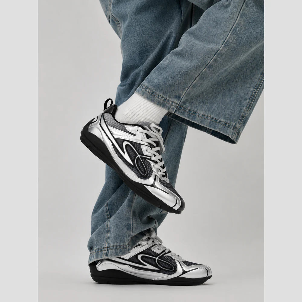 None Unit Meteor Wave Low Sneaker in meteor silver styled standing view