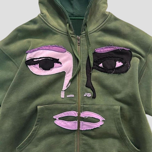 Sudadera con capucha y cremallera con diseño de patchwork de personajes