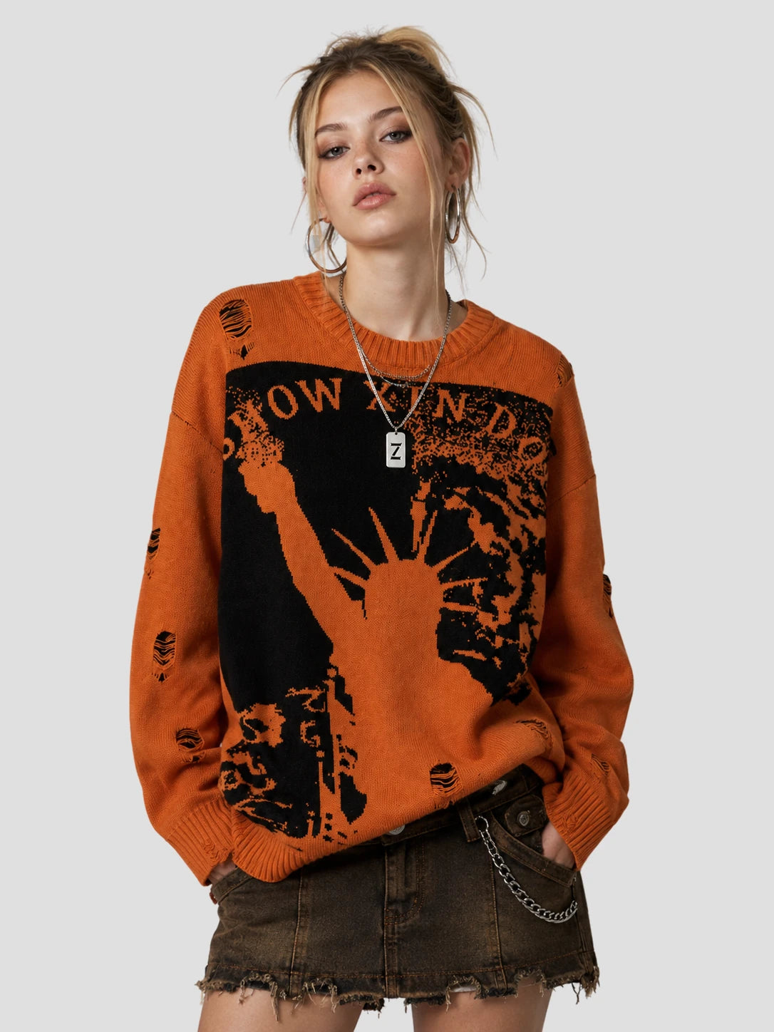 None Unit Liberty Hand Distressed Graphic Sweater in orange female model front view