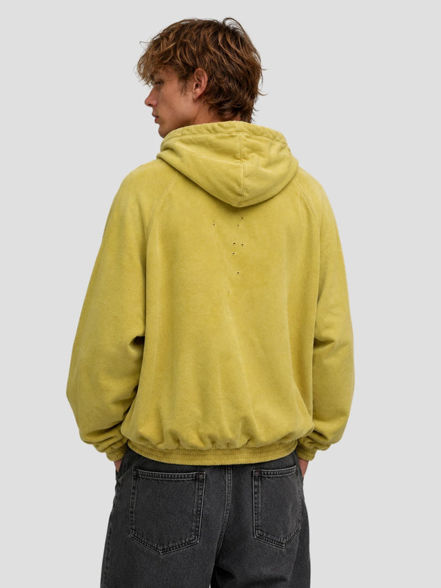 None Unit Yellow Shield Washed Hoodie in mustard yellow male model back view